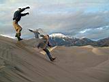 052_ken_bill_jan_jumping_down_dunes.jpg